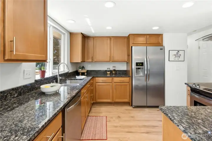 Another view of the kitchen with easy-care luxury vinyl tile flooring.
