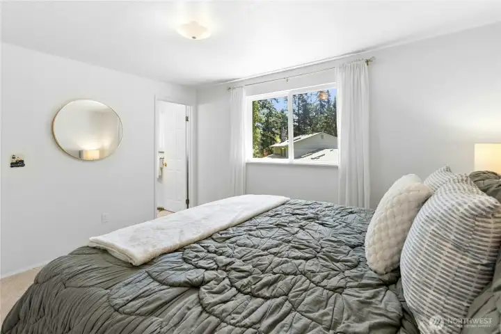 Primary bedroom with a view of the 3/4 bath.