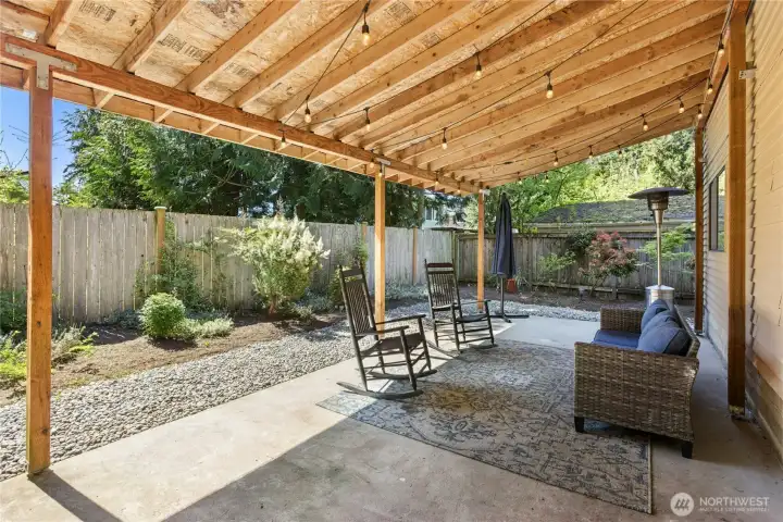 This covered back patio is sure to be a popular place to relax.