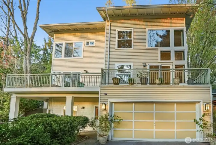 Stunning home tucked in woods with 2-car garage.