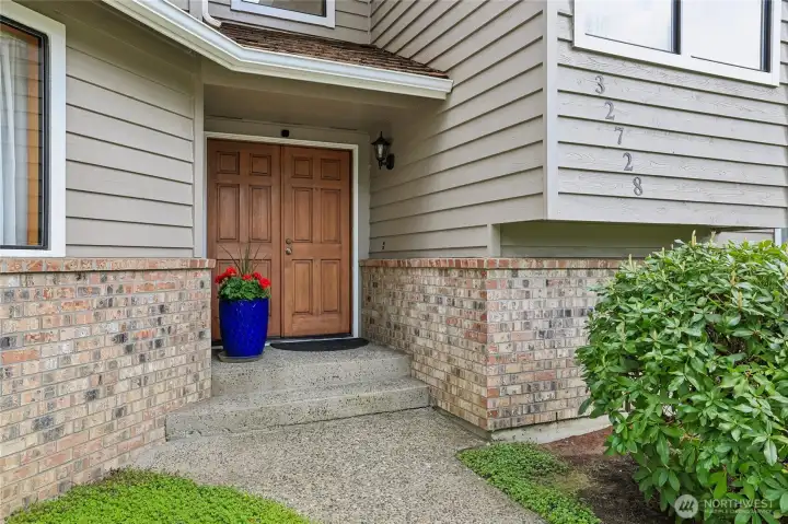Inviting covered front porch and double door entry.