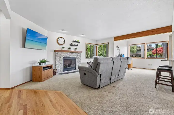 Family room offers a modern gas fireplace and bright windows