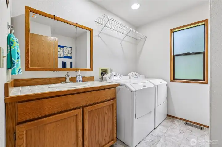 Utility room with 3/4 bath (shower is across from washer/dryer)