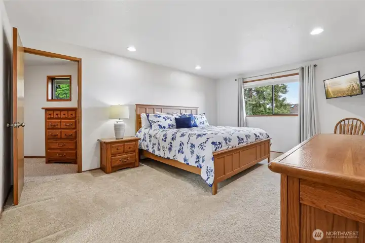 Expansive primary suite - your private retreat at the end of the day. This back hallway with extensive storage is a secondary passage to the bonus room!