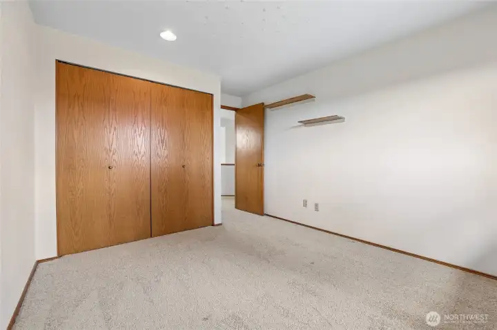 Spacious third bedroom or guest room with neutral tones and ample closet space.