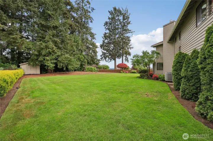 Park-like backyard with plenty of room for play, gardening, or relaxing.