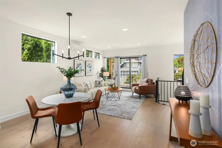 Spacious dining and living room with direct access to the covered deck overlooking the fully fenced front yard