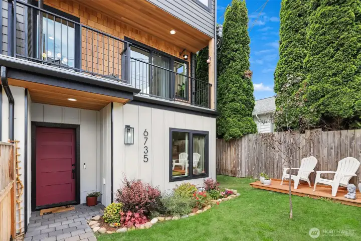 The covered deck overlooking the fully fenced front yard