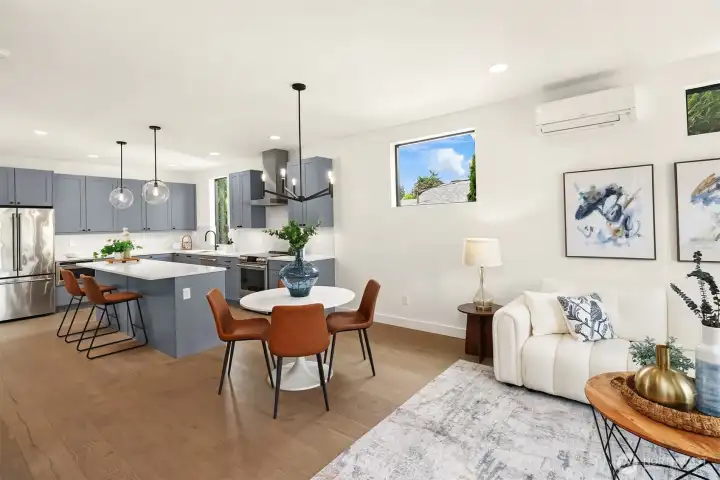 Spacious dining and living room with direct access to the covered deck overlooking the fully fenced front yard