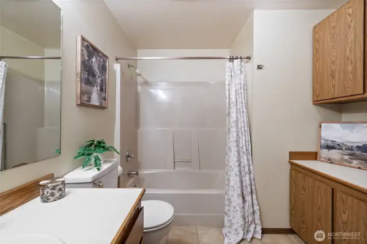 Full Guest Bath off hallway with additional storage and vanity space