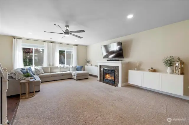 Spacious and welcoming family room. Gas fireplace flanked by white cabinetry.