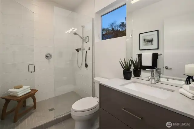 En suite bath to the second primary bedroom.
