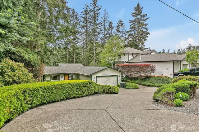 This home is perfectly nestled in a beautifully manicured, park-like setting.