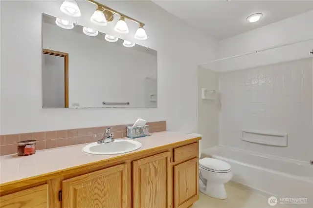 Full bath with a tub/shower combo.