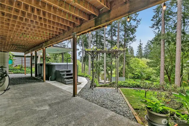 Lower level patio with swim spa and stairs leading to the dock and clubhouse.