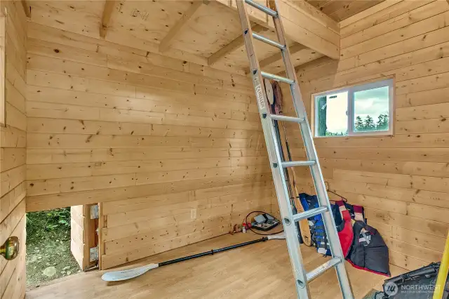 Inside the cabin with pine paneling.