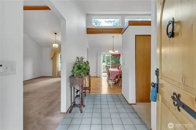 The entry opens to vaulted ceilings and clerestory windows that fill the main living areas with natural light.