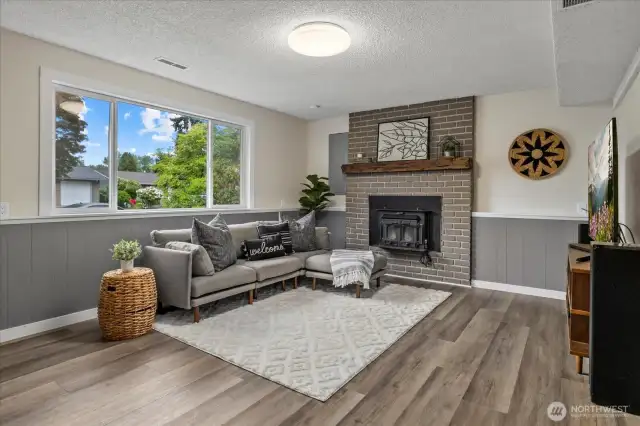 Lower level living room. Cozy up to the wood fireplace.