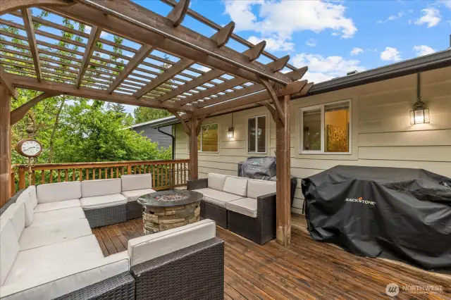Entertain with ease on the oversized deck—complete with a pergola and relaxing hot tub, both of which stay.