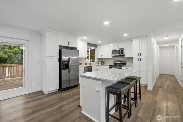 The kitchen shines with granite counters, stainless steel appliances including a double oven, and LVP flooring.