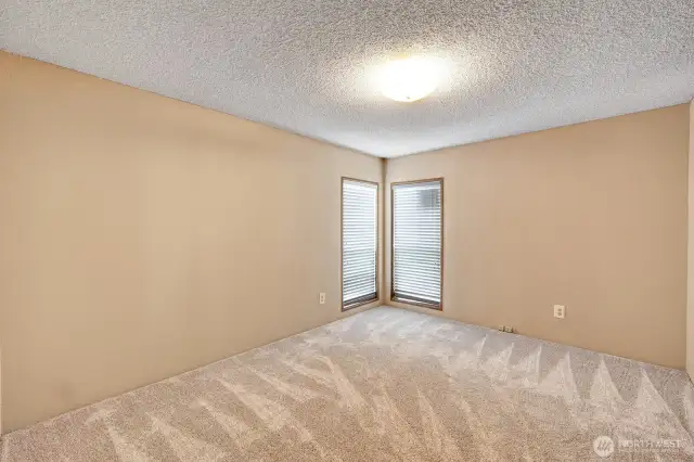 Guest bedroom #2 at the southwest end of the home. Floor to ceiling widows bring in ample natural light. Custom plantation blinds for privacy.