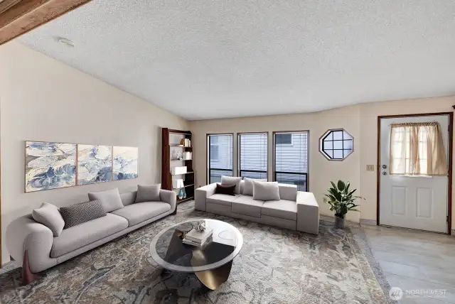Tile at the formal entry into the home. Vaulted ceilings, textured walls, neutral color scheme and floor to ceiling windows are just some of the interior features of this home.