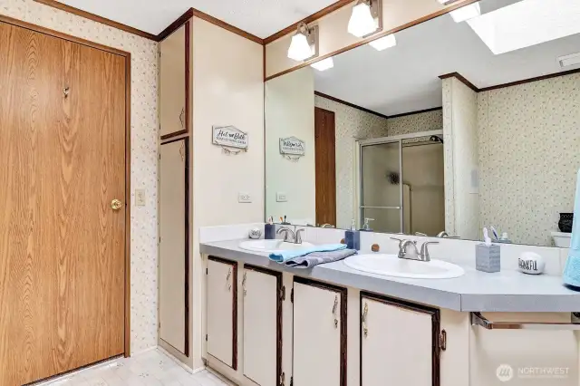 Private, 4-piece primary bath. Tons of storage cabinets and shelves for all personal items and necessities. Open area with easy access for walker or wheelchair.