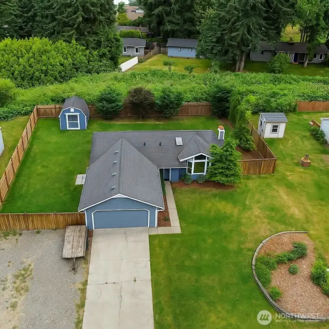 Spacious yard with green area behind