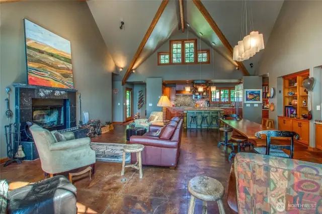 The great room looking toward the kitchen. Primary suite is to the left, den to the right