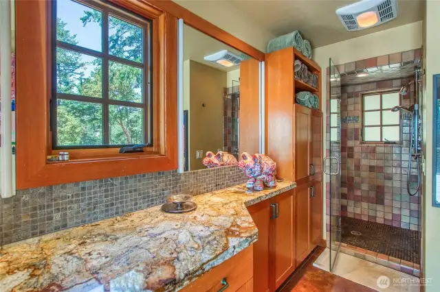 Beautiful cabinets and counters with tiled shower