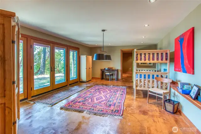 The rec area on the lower floor with a bonus room beyond