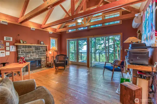 The guest space/art studio in the Guest Cottage has a sink and is ideal for a variety of uses. Has both a stone fireplace and a mini split