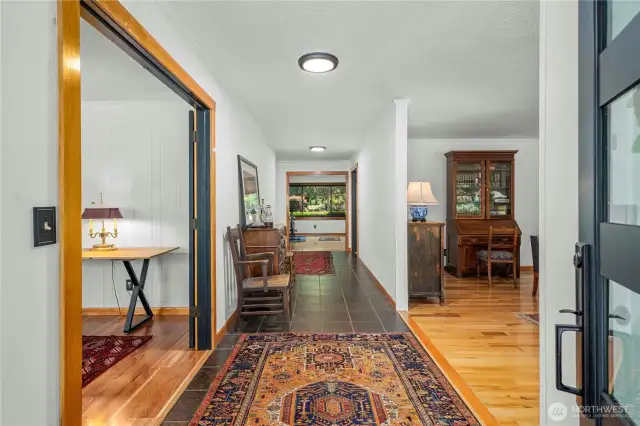 The tiled hallway leads to the rear of the home. To your left is one of 2 large receiving room, on the right is the grand-piano sized formal living room.