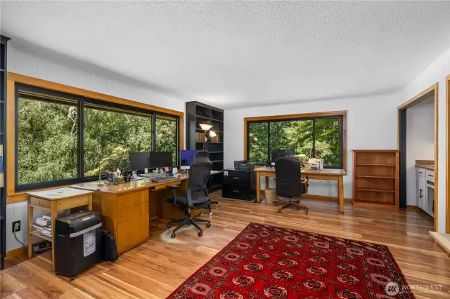 Gorgeous 2019 windows framed in VG fir enhance this room currently being used as an office by the owners.  It has a wet bar and could also serve as a formal dining room.