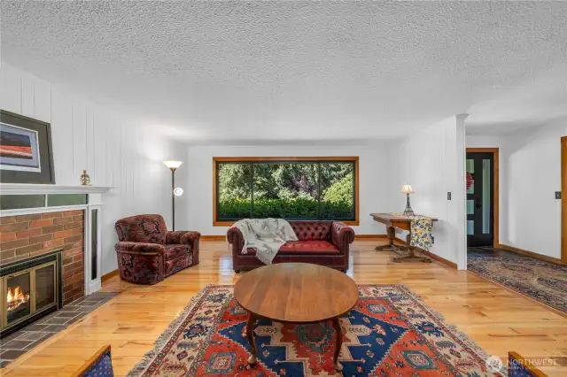 View two of the formal living room, the window looks over the mature landscaping at the front of the home