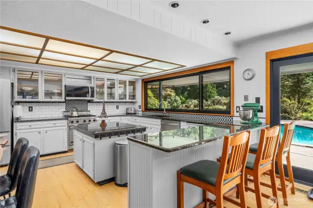 The kitchen features ss appliances, granite counter tops, subway backsplash and an island. It is a wonderful place to cook and entertain in.