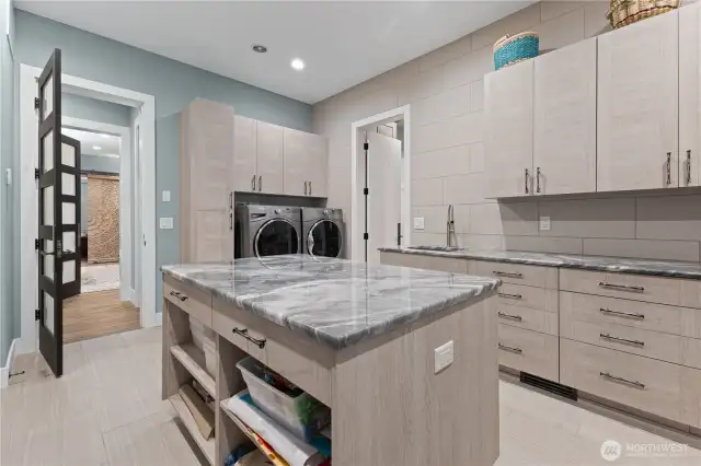 Downstairs laundry connected to primary bedroom closet