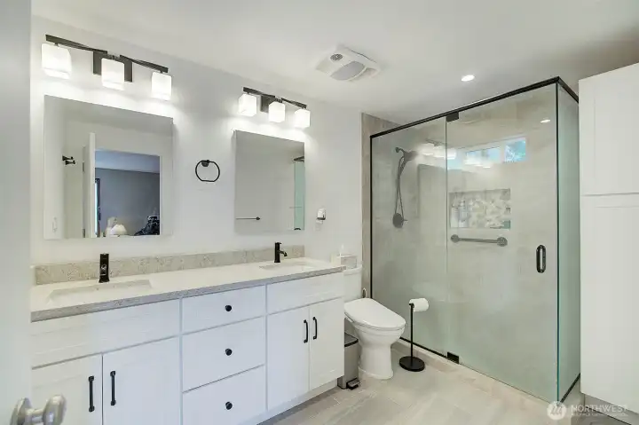 This primary 3/4 bath features heated floors and a walk in tile shower.