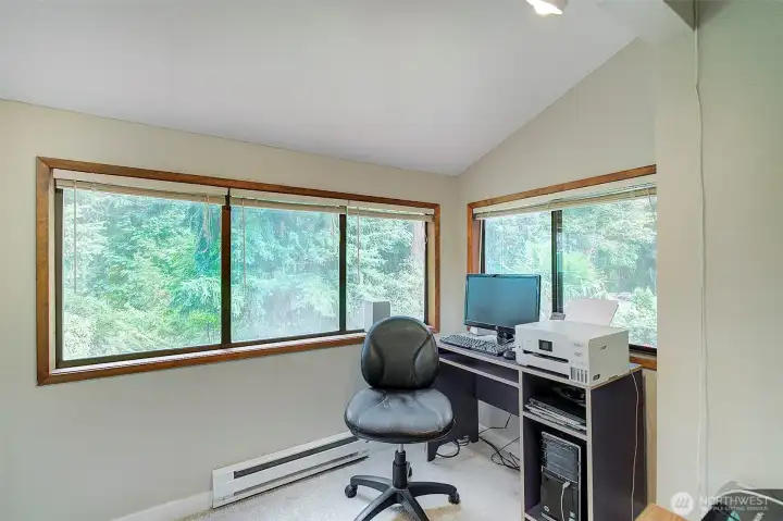 Den/office upstairs has lots of windows that look out at all the trees. New carpet installed.