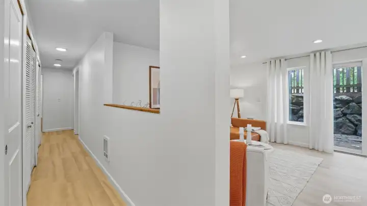 The hallway is lined with storage closets.