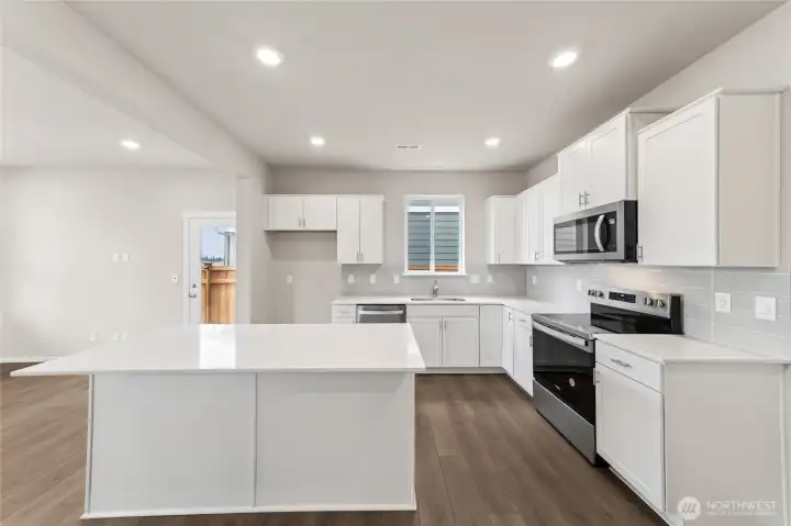 Enjoy clean lines, shaker cabinets, and a quartz island centerpiece—perfect for prep, serving, and gathering.  Pictures are for representational purposes only, colors and features may vary.