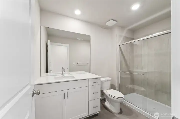 Stylish and functional bathroom featuring a tiled shower with glass doors, sleek vanity, and modern finishes.  Pictures are for representational purposes only, colors and features may vary.