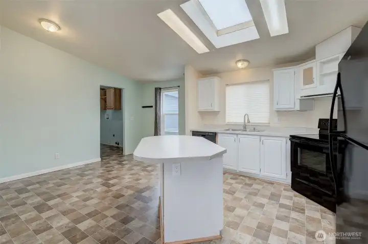 Kitchen with eating island and room for dining room table.