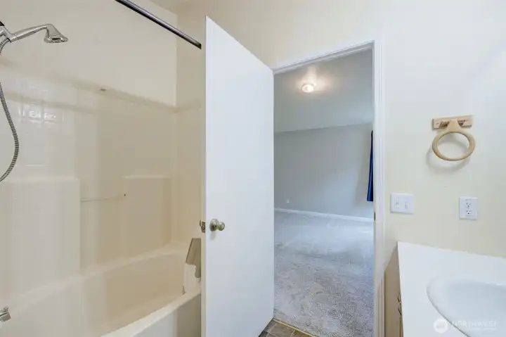 Primary bathroom with soaking tub and shower.