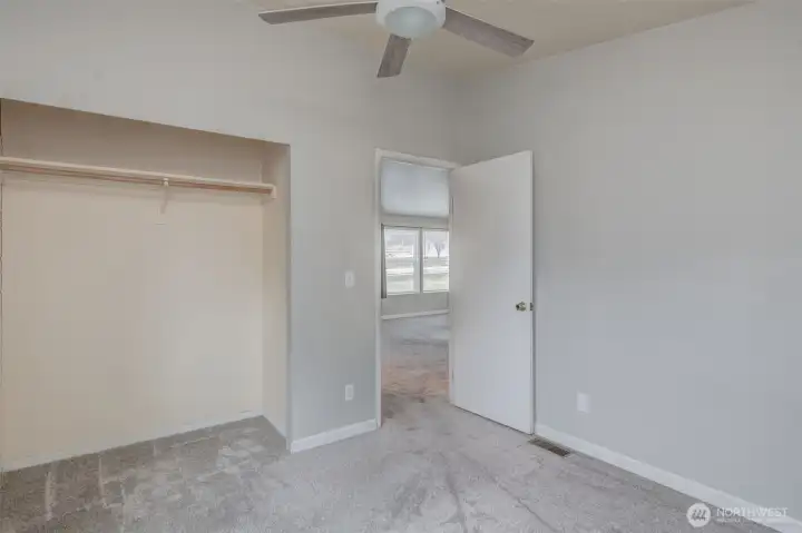 2nd bedroom with closet and ceiling fan.