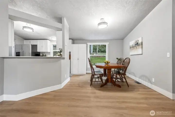 Bright and open, the kitchen flows naturally into the adjacent living areas. The dining area offers a comfortable space for meals or gatherings. Natural light enhances the inviting atmosphere. It’s a perfect spot to enjoy good food and great company.