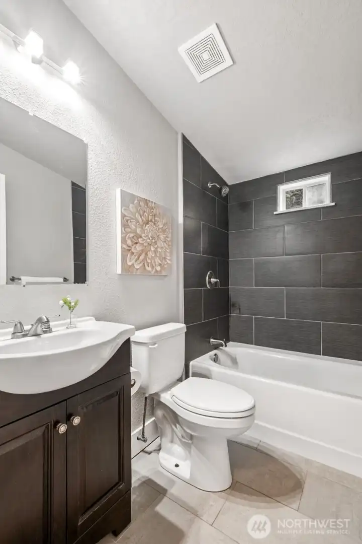 Both bathrooms have been refreshed with stylish tile and updated fixtures. The modern touches elevate the entire home’s aesthetic. It’s a move-in-ready upgrade that adds lasting value.