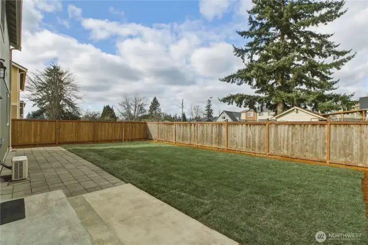 Fully fenced backyard with new lawn!  Oversized patio.  Border for flowers & veggies.