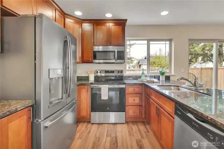 Stainless steel appliances, _____________wood to-the-ceiling cabinetry, granite counters.  Light & Bright!