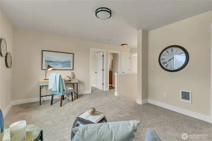Stairway from main level just to left of clock.  Arrival to the Family Room/Loft.  The doors in the background are to side-bedrooms & bath.